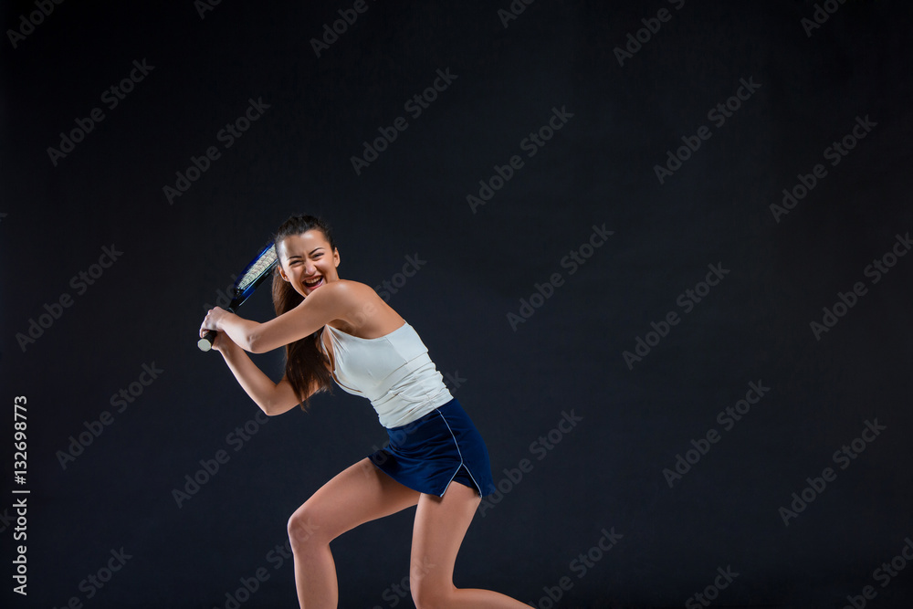 Portrait of beautiful girl tennis player with a racket on dark background Portrait of beautiful girl tennis player with a racket on dark background