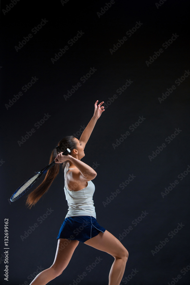 Portrait of beautiful girl tennis player with a racket on dark background Portrait of beautiful girl tennis player with a racket on dark background