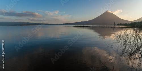 Volcano Arenal in the early morning with reflection in the water