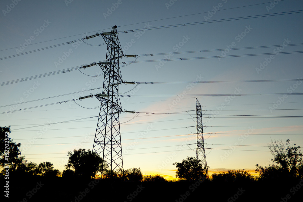 Fototapeta premium Towers supporting power lines in the twilight