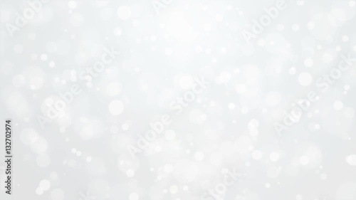 Beautiful glowing silver white bokeh background with flickering light particles.