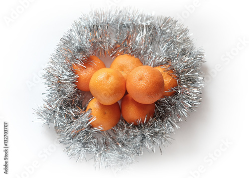 Oranges in Christmas foil isolated on white
