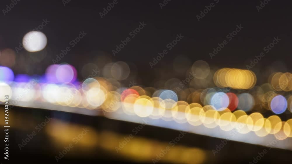 Defocused night lights of cars traffic on the city bridge. Seamless loop time lapse video.