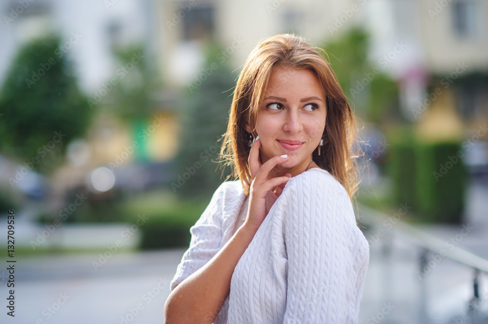 young smiling woman posing on background of city young smiling woman posing on background of city