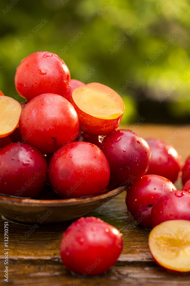Fresh bright plums on wooden background Fresh bright plums on wooden background