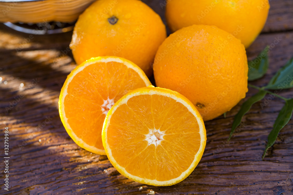 Sweet fresh oranges in natural light on old wood Sweet fresh oranges in natural light on old wood