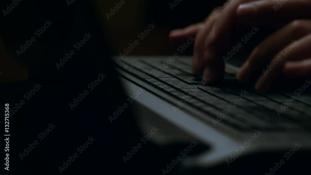 Hands Typing On A Laptop Keyboard. Dark Theme