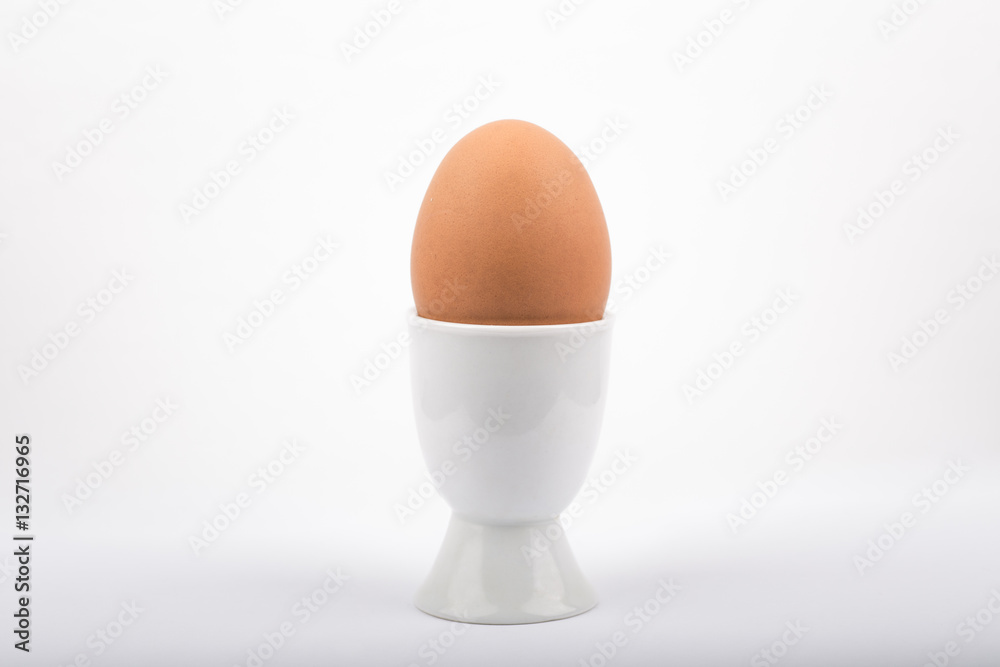 Egg in a egg cup on a white background