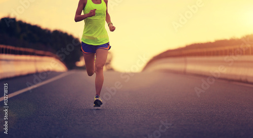 young fitness asian woman runner running on city road