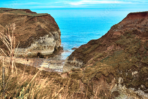 A view of the beach and surrounding rock at the North Landing at Flamborough Head on the north Yorkshire coast.