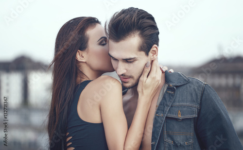 Canvastavla Young woman whispering love into boyfriend ear