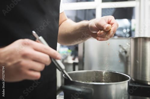 Pouring spices to the soup