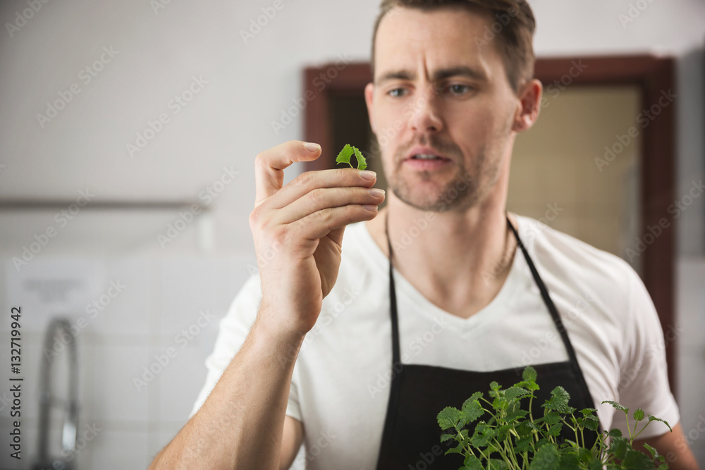 Chef holding small piece of lemon