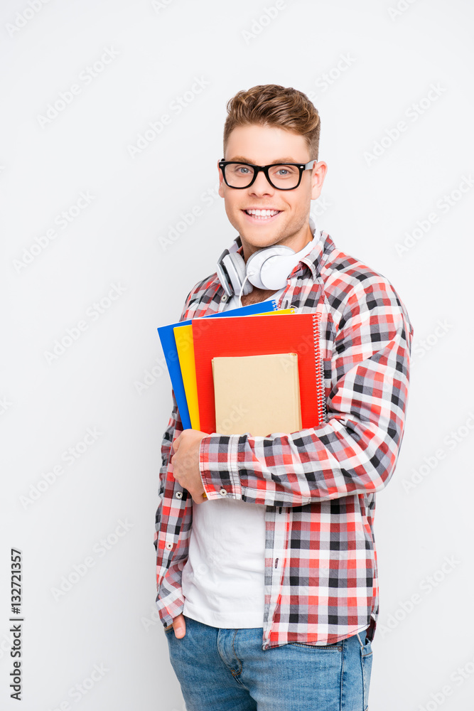 Portrait of smart happy student in glasses holding notebook