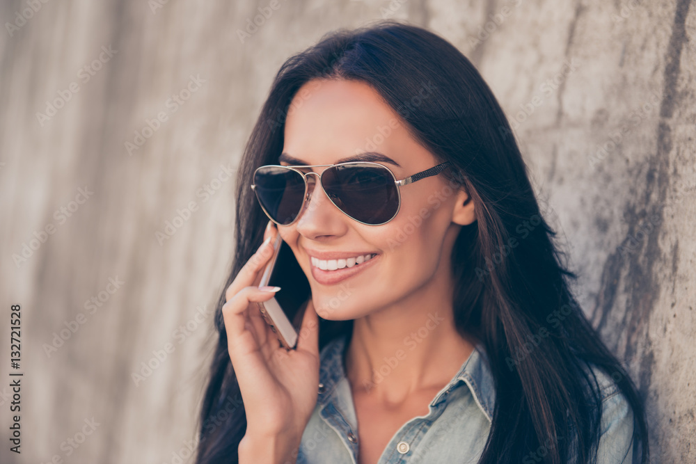 Portrait of happy young woman in glasses talking on cell phone Portrait of happy young woman in glasses talking on cell phone