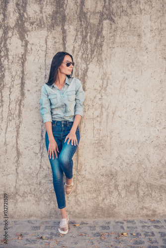 Beautiful brunette girl wearing jeans clothes in a modern city