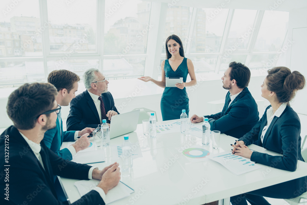 Young woman in a meeting making presentation in a conference roo Young woman in a meeting making presentation in a conference roo