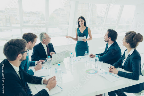 Young woman in a meeting making presentation in a conference roo