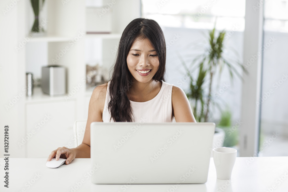 Asian Woman Surfing the Net at Home Asian Woman Surfing the Net at Home