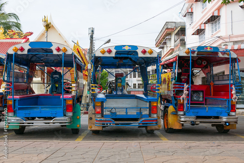 Blue funny rickshaws (tuk tuk) lined up in the street of Bankok, Thailand. Rear view.