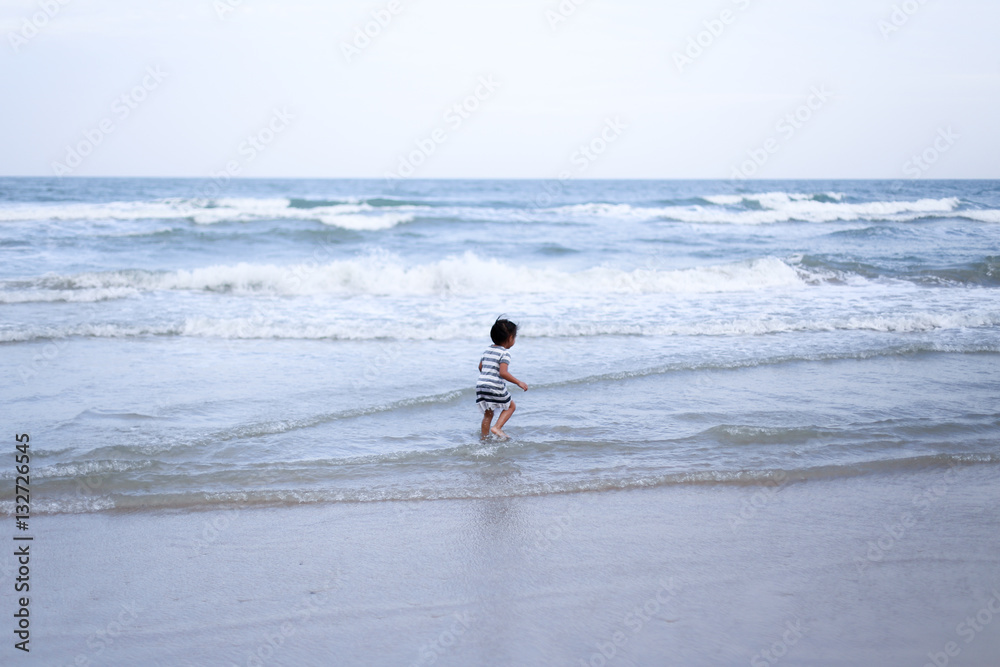 Children playing at the beach in summer