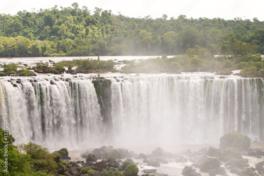 Fototapeta premium Iguazu (Iguacu) falls, largest series of waterfalls on the planet, located between Brazil, Argentina, and Paraguay with up to 275 separate waterfalls cascading along 2,700 meters (1.6 miles) cliffs.