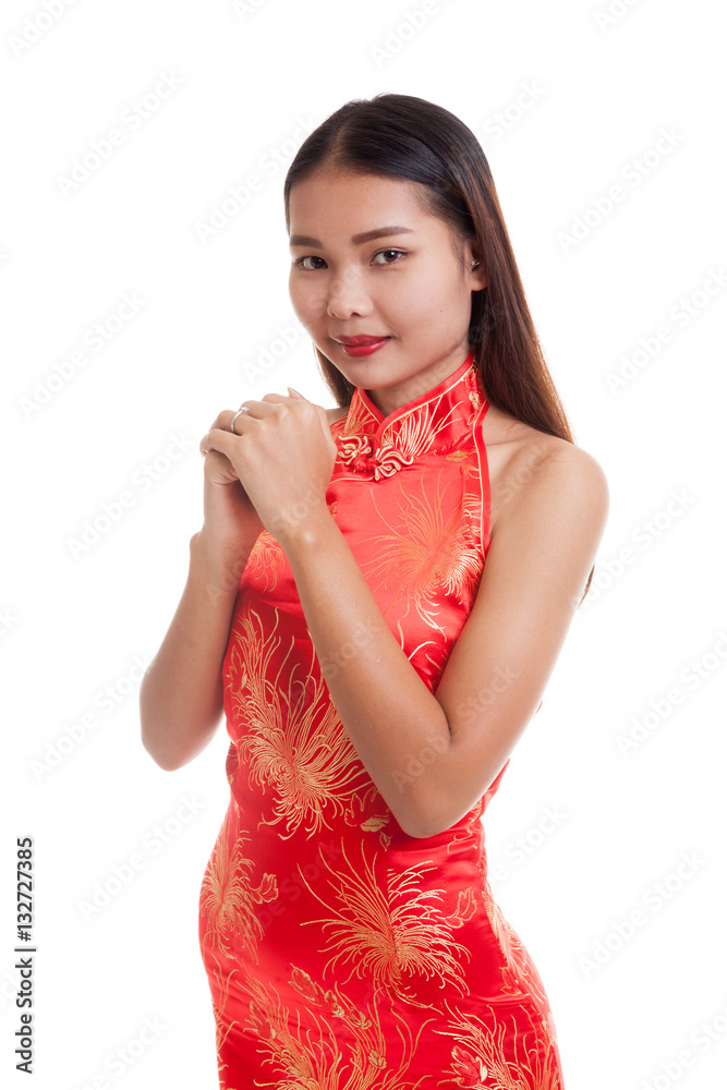 Asian girl in chinese cheongsam dress with gesture of congratula Asian girl in chinese cheongsam dress with gesture of congratula