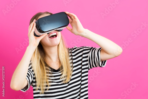 Young woman using virtual reality headset
