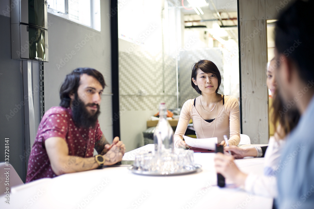 Japanese businesswoman and caucasian colleagues in an office meeting