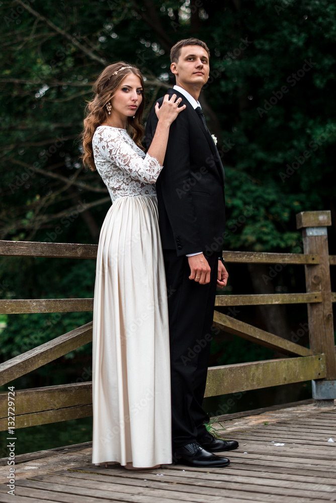happy bride and groom at a park on their wedding day happy bride and groom at a park on their wedding day