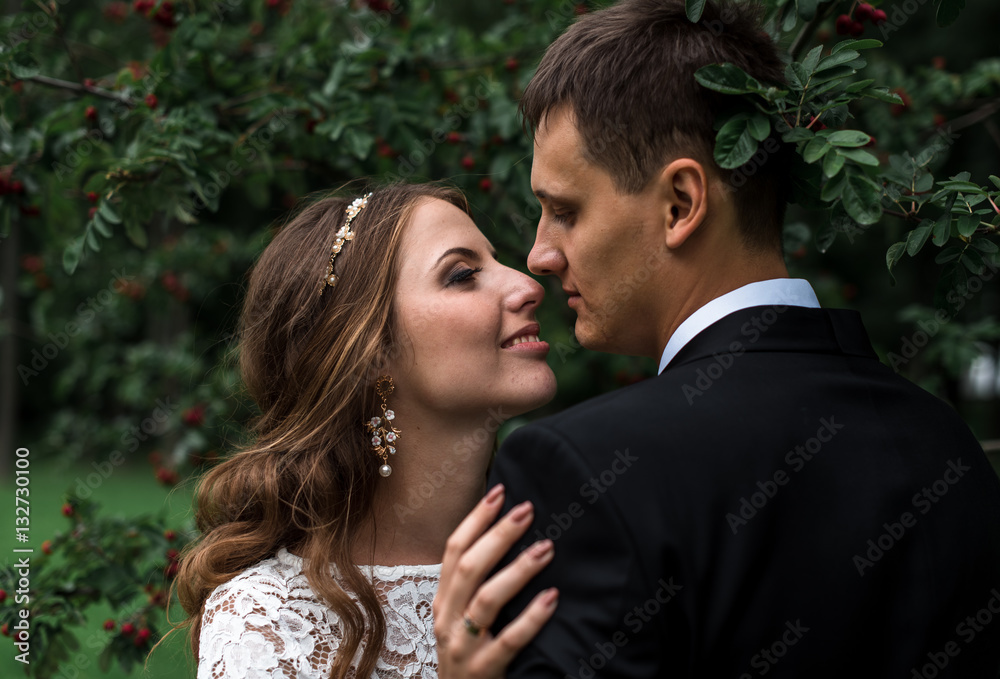 happy bride and groom at a park on their wedding day happy bride and groom at a park on their wedding day