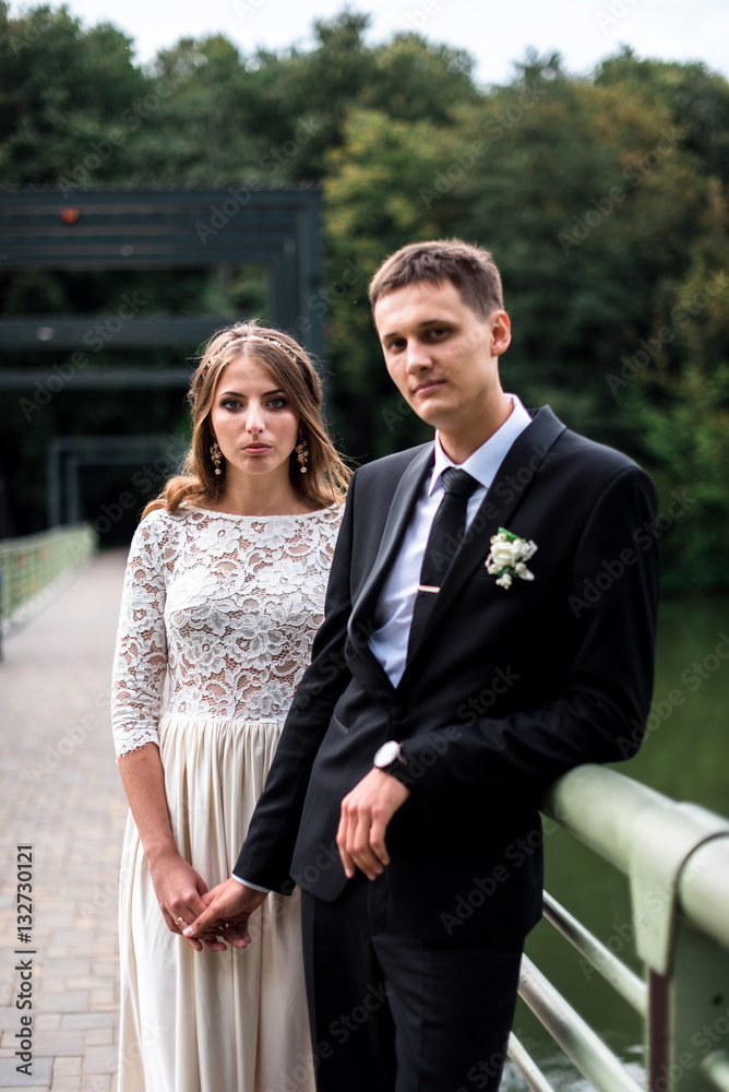 happy bride and groom at a park on their wedding day happy bride and groom at a park on their wedding day