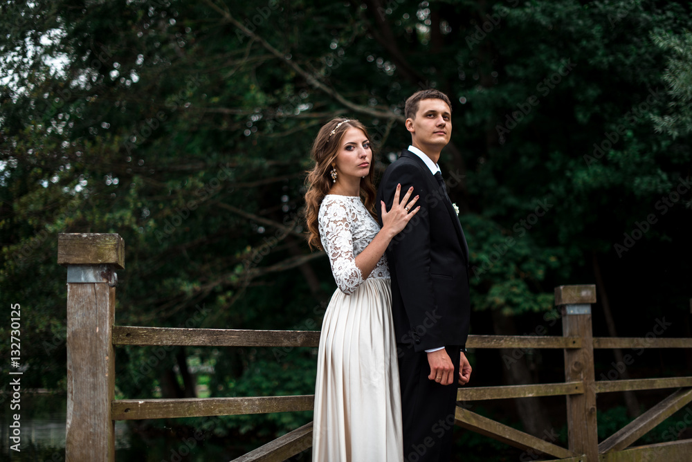 happy bride and groom at a park on their wedding day happy bride and groom at a park on their wedding day