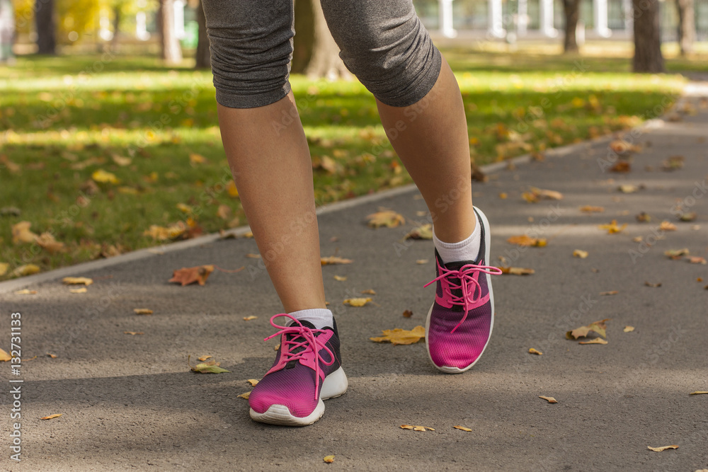 Runner woman feet running on road closeup on shoe. Fitness woman in training shoes jogging outdoors in park. Sport active lifestyle
Runner woman feet running on road closeup on shoe. Fitness woman in training shoes jogging outdoors in park. Sport active lifestyle