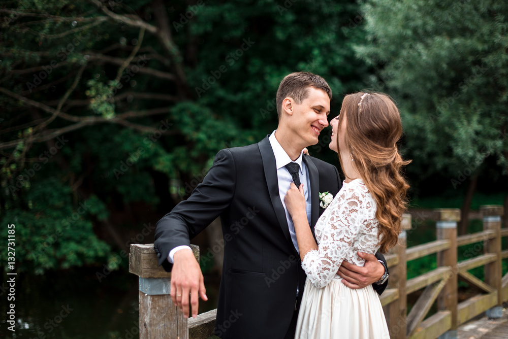 happy bride and groom at a park on their wedding day happy bride and groom at a park on their wedding day