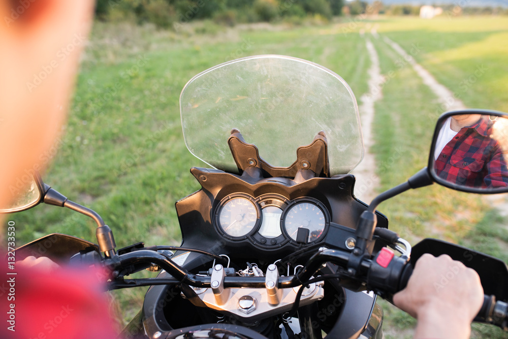 Fototapeta premium Unrecognizable man enjoying a motorbike ride in countryside.