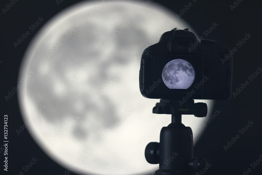 Fototapeta premium Moon photography. Camera with tripod capturing moon.