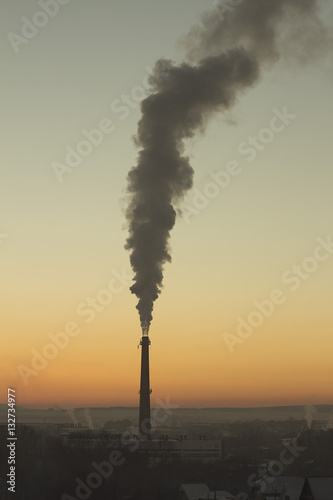 industrial chimney at sunset in winter