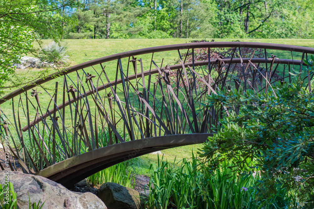 Artistic bridge in green lush garden setting. Sarah P. Duke gardens in Durham, NC.