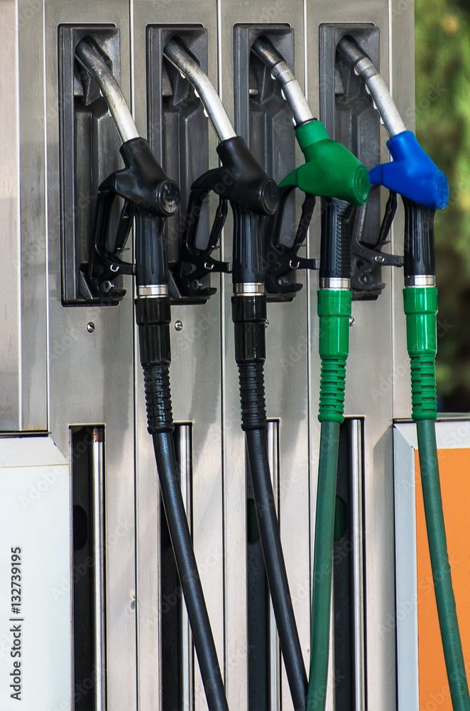 Four refueling nozzles on gas station. Four refueling nozzles on gas station.