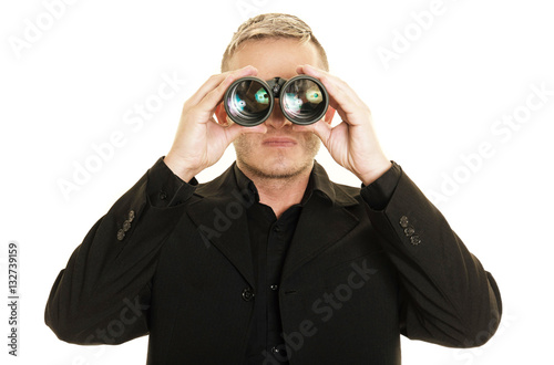 Businessman is looking through binoculars