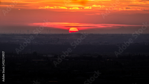 sunset on Po Valley view from Bergamo hill's - is visible on the horizon the skyline of Milan city