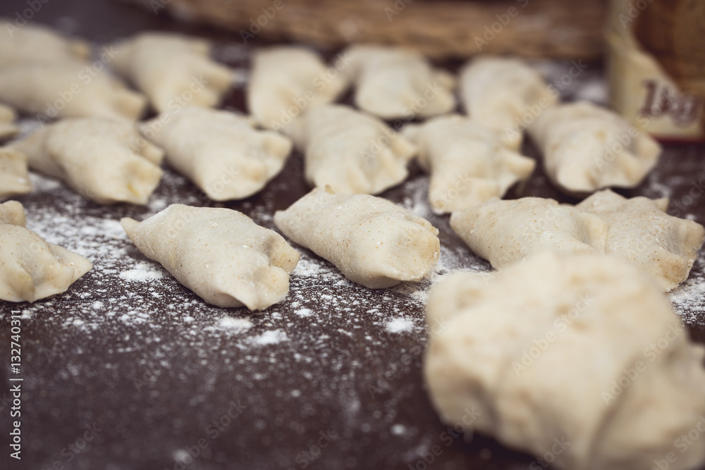Homemade Dumplings prepared on the wooden brown table by traditional way Homemade Dumplings prepared on the wooden brown table by traditional way