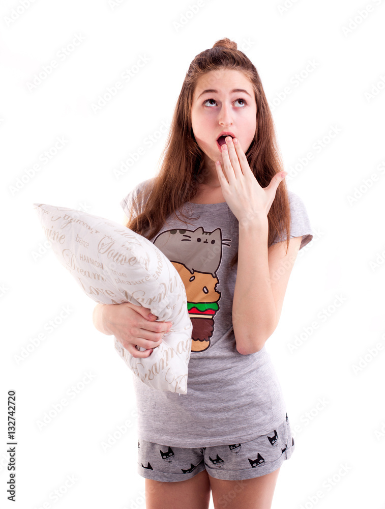 Isolated shot of pretty girl yawing and hold pillow isolated Isolated shot of pretty girl yawing and hold pillow isolated