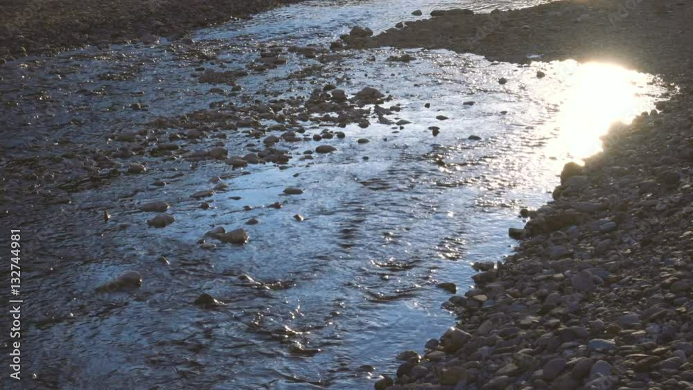 Mountain stream flowing on the rocks at sunset Mountain stream flowing on the rocks at sunset