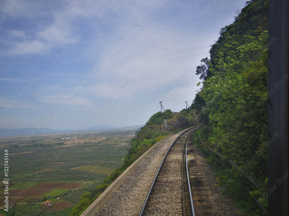 View through rear window of train travelling through mountains.. View through rear window of train travelling through mountains..