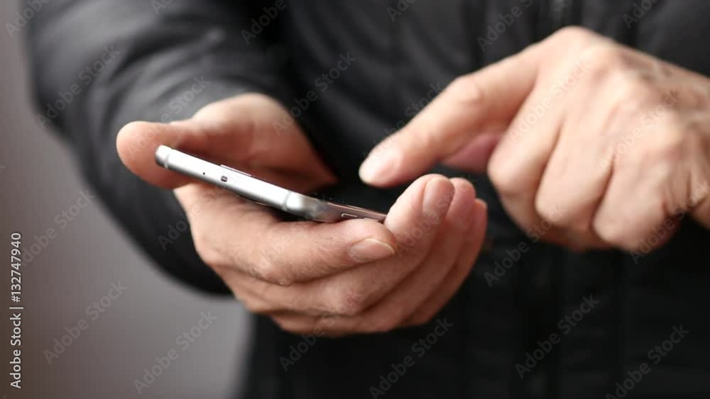 Old Man In Black Jacket Text Messaging On Smartphone. White Background