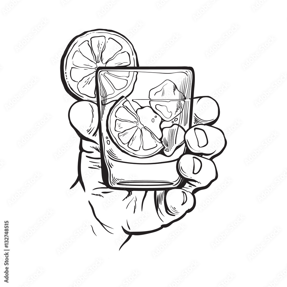 Hand holding glass of gin, vodka, soda water with ice and lime slices