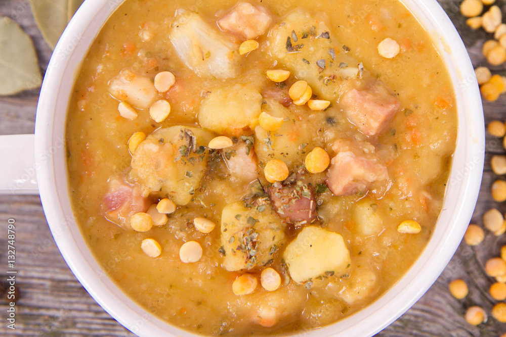 Split pea soup, decorated with some bay leaves, marjoram and peas Split pea soup, decorated with some bay leaves, marjoram and peas