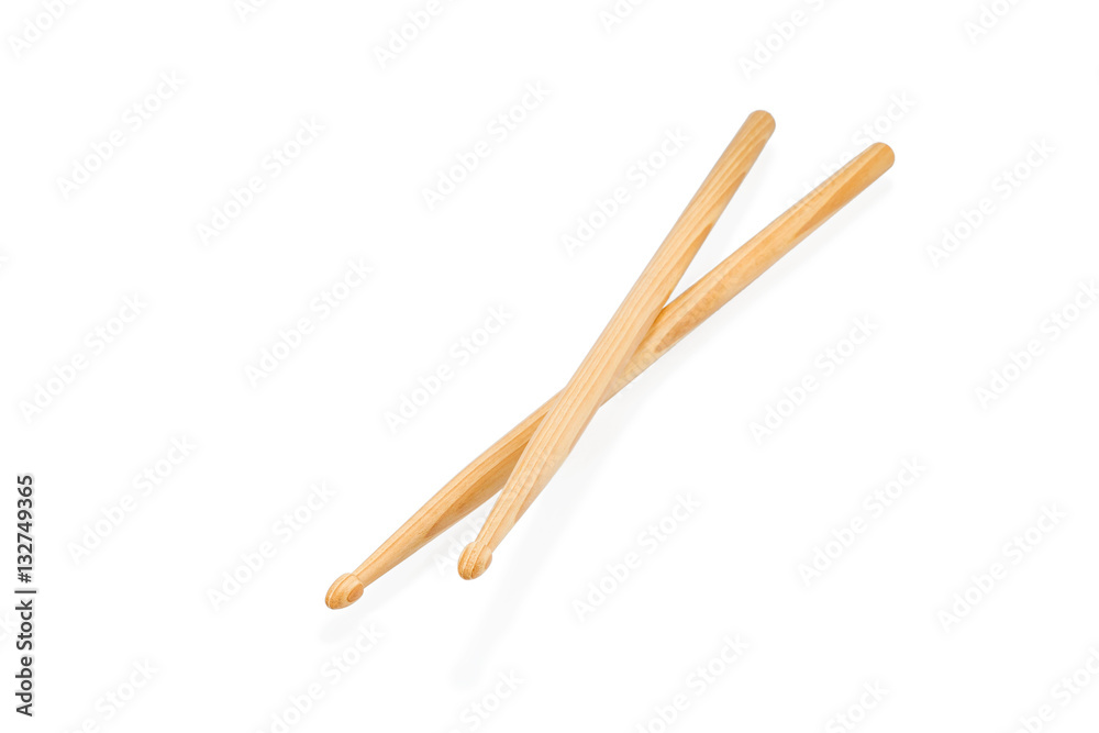 Two wooden drum sticks lying on each other isolated on white background